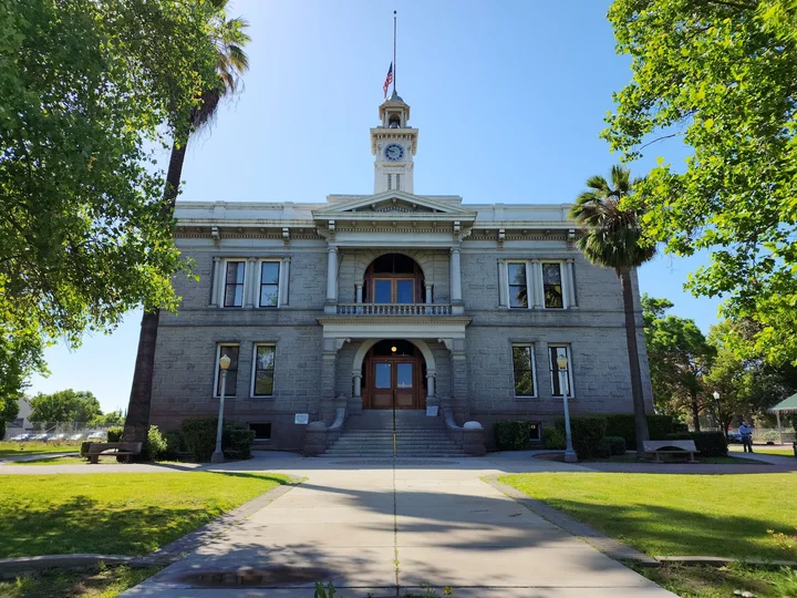 Historic Madera County Courthouse surrounded by mature trees